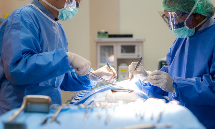 Graduate medical students assist in surgical procedure