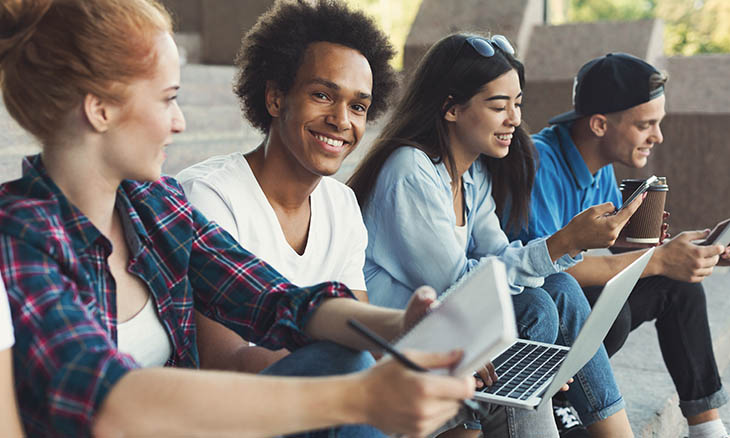 Teens gathered around in a group