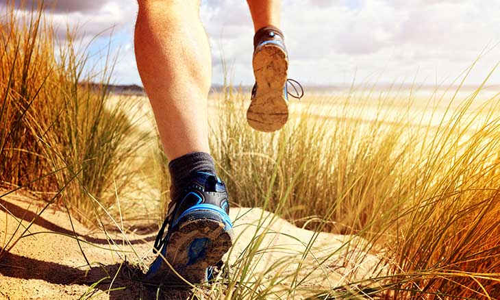 Person running on a dirt path