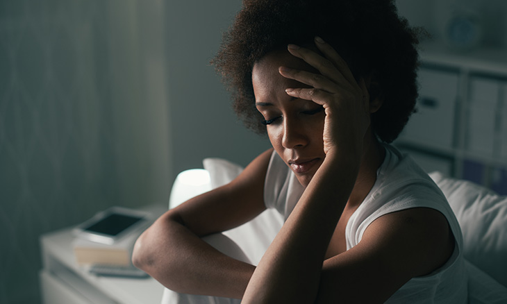 Woman up in bed having trouble sleeping