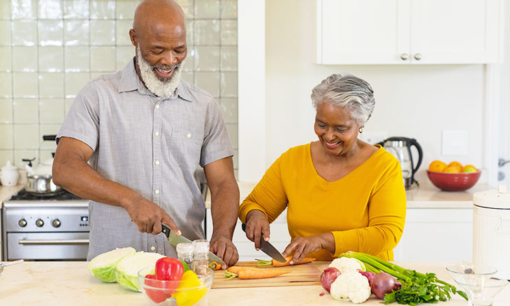 An older couple cooks a health meal together