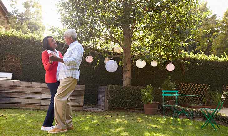 Older couple dancing outside to stay active during COVID-19 quarantine