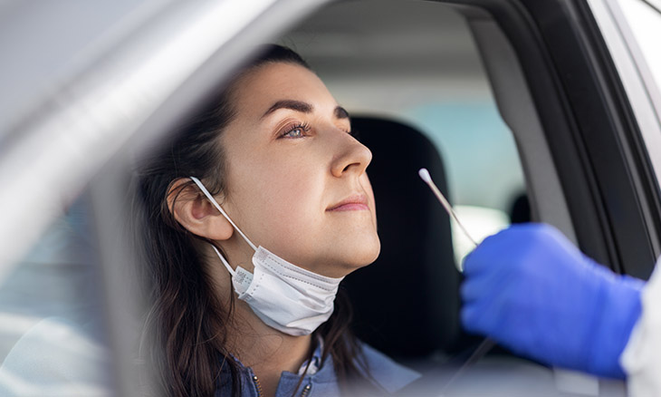 Woman getting tested for COVID-19 at drive-through site
