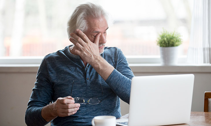 Man at computer with eye pain.