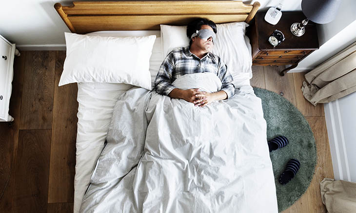 Man sleeping soundly in his bed