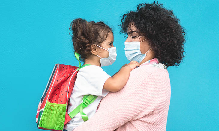 Mom hugs preschooler before school