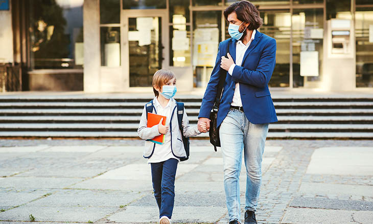 Father and son walk home from school
