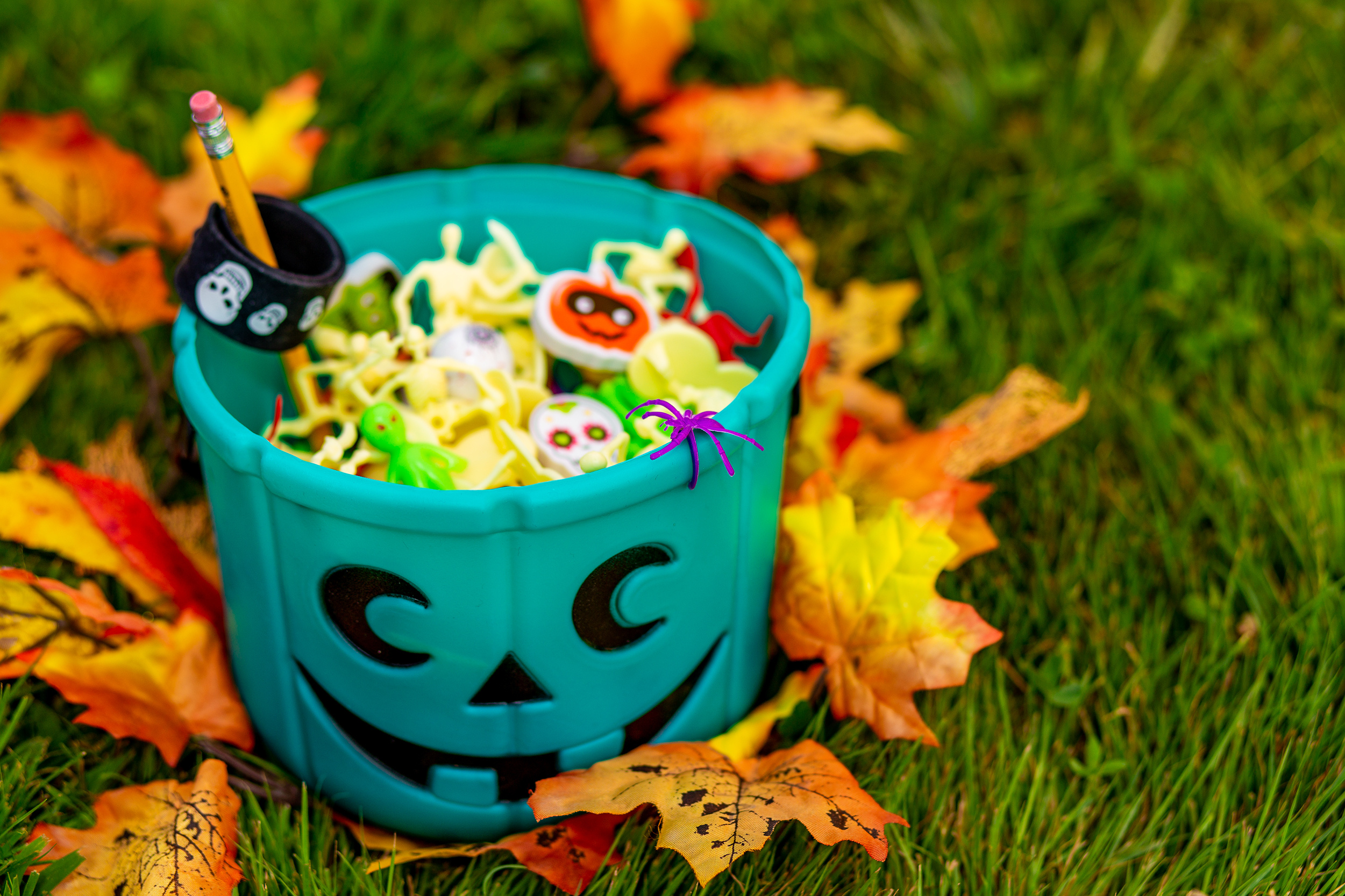 Halloween pumpkin basket filled with little toys