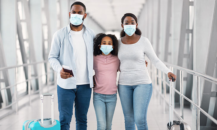 Family wears masks in airport