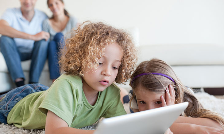 Children look at tablet screen and social media
