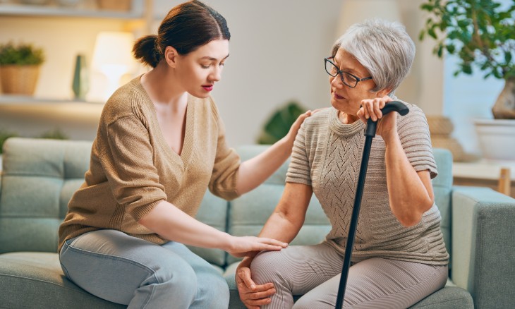A young woman cares for an elderly woman.