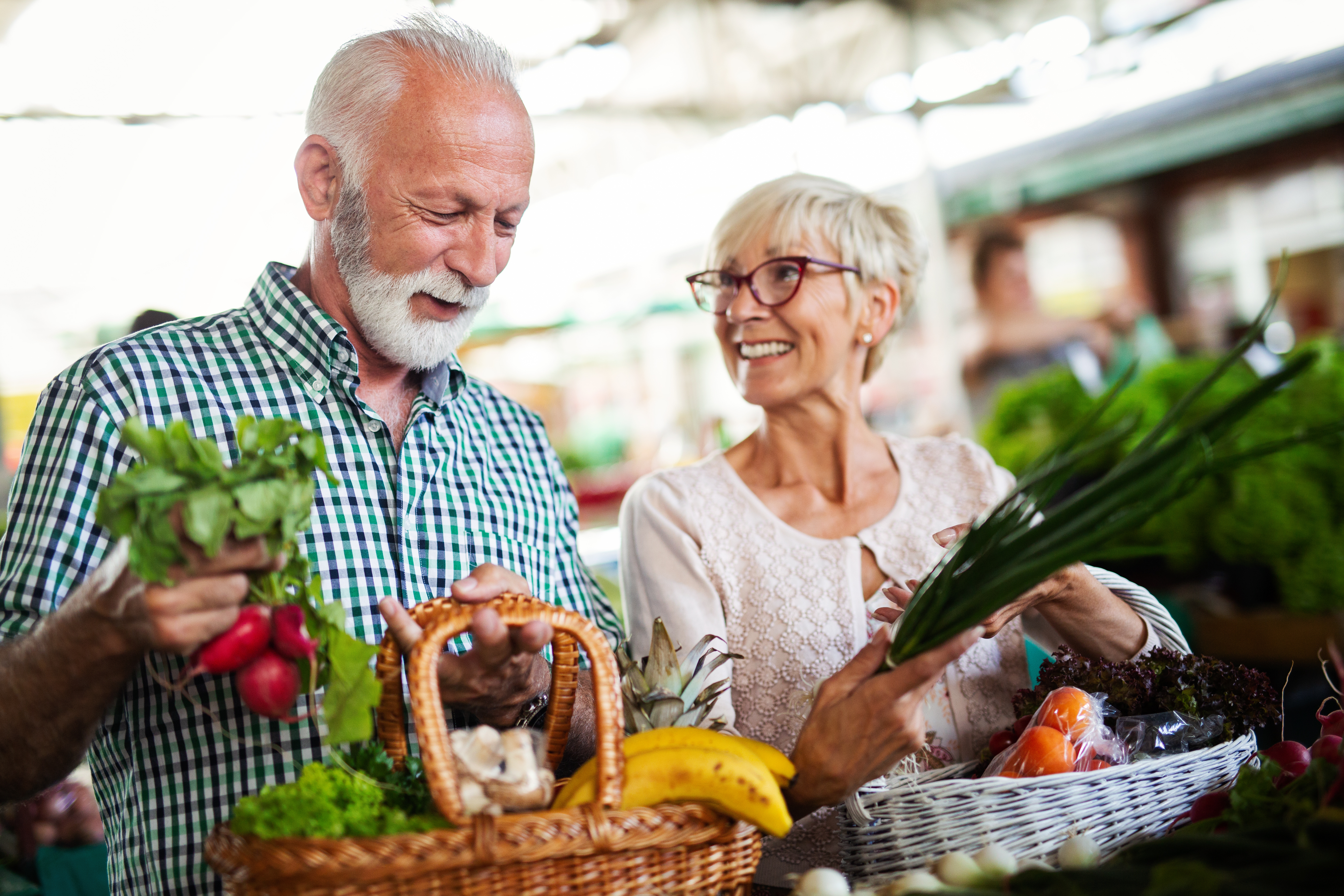 Couple find fresh fruits and vegetables at local farmer's market.