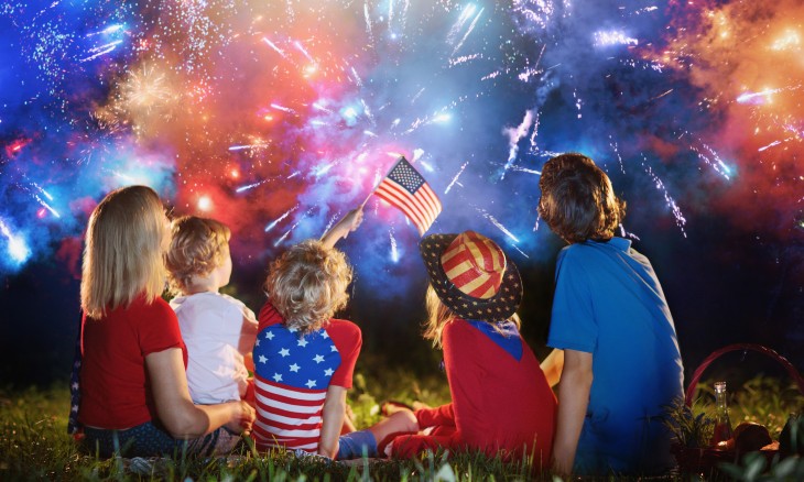 A family with children watching fireworks on Independence Day.