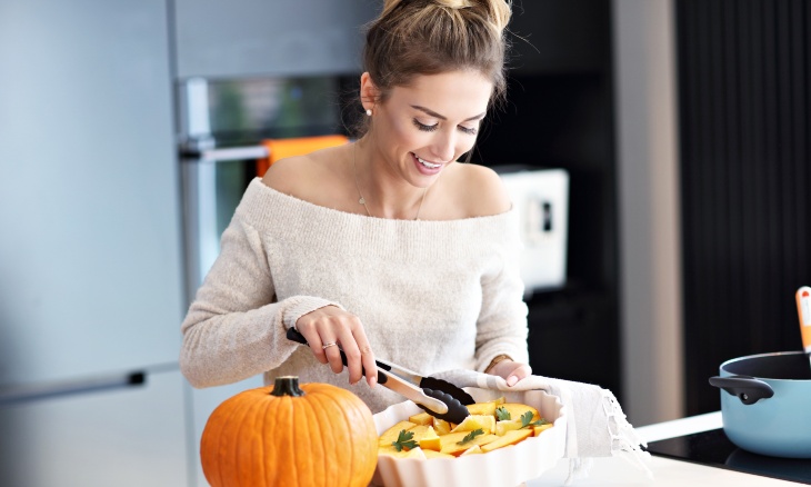 A woman prepares a fall meal