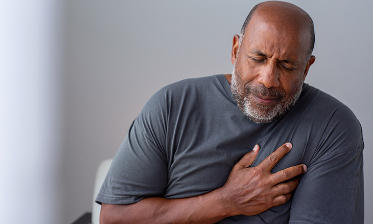 A man clutches his chest during a heart attack