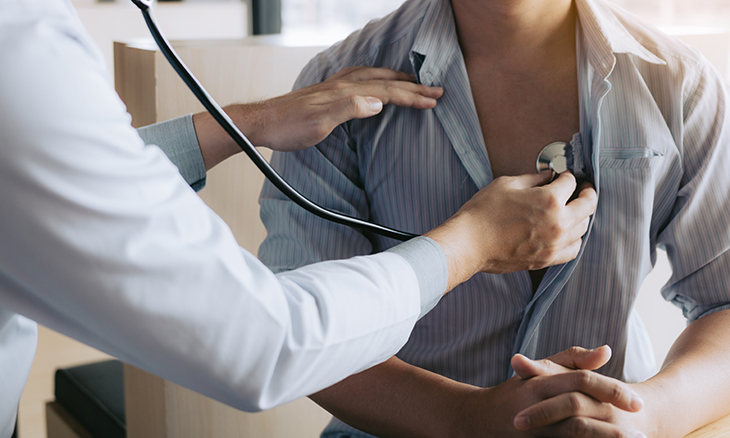 A doctor checks a patient's heart
