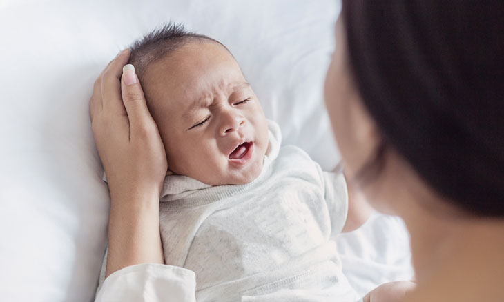 Mom comforting sick infant