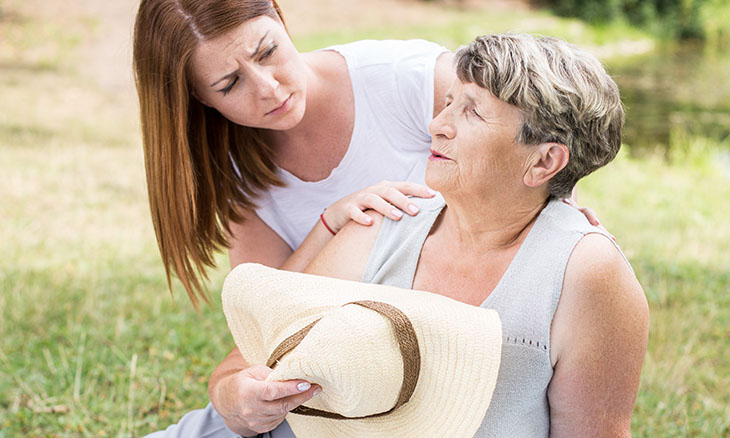 A woman helps her mom in the heat