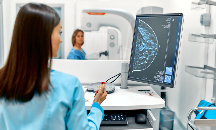 Technician evaluates mammography images