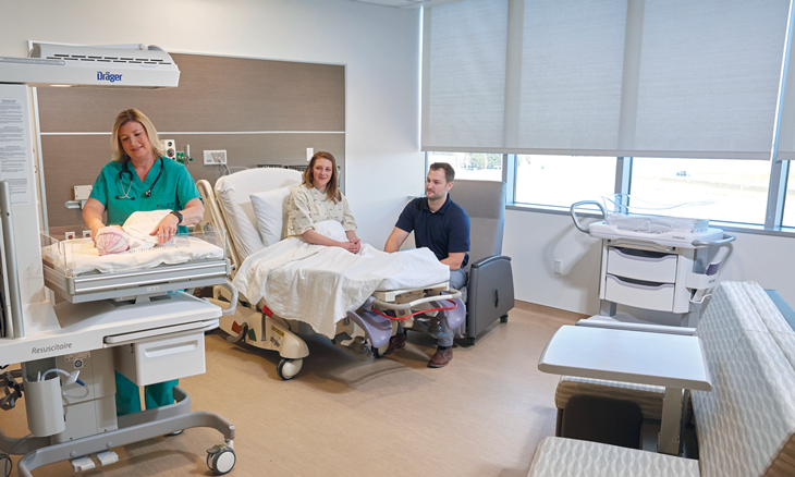 Parents and infant in delivery room