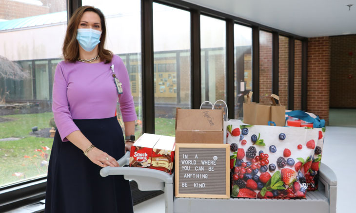 Carrie Hart from volunteer services collect Bayhealth's donations to Code Purple for MLK Day