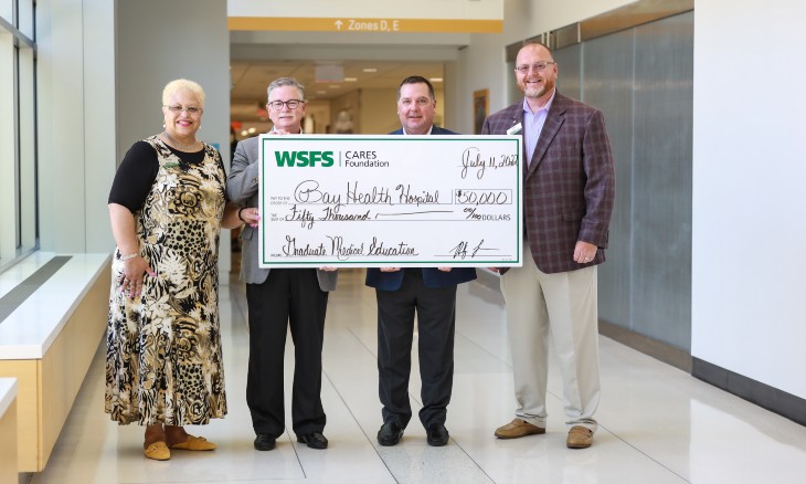 Bayhealth employees receive a donation from WSFS.