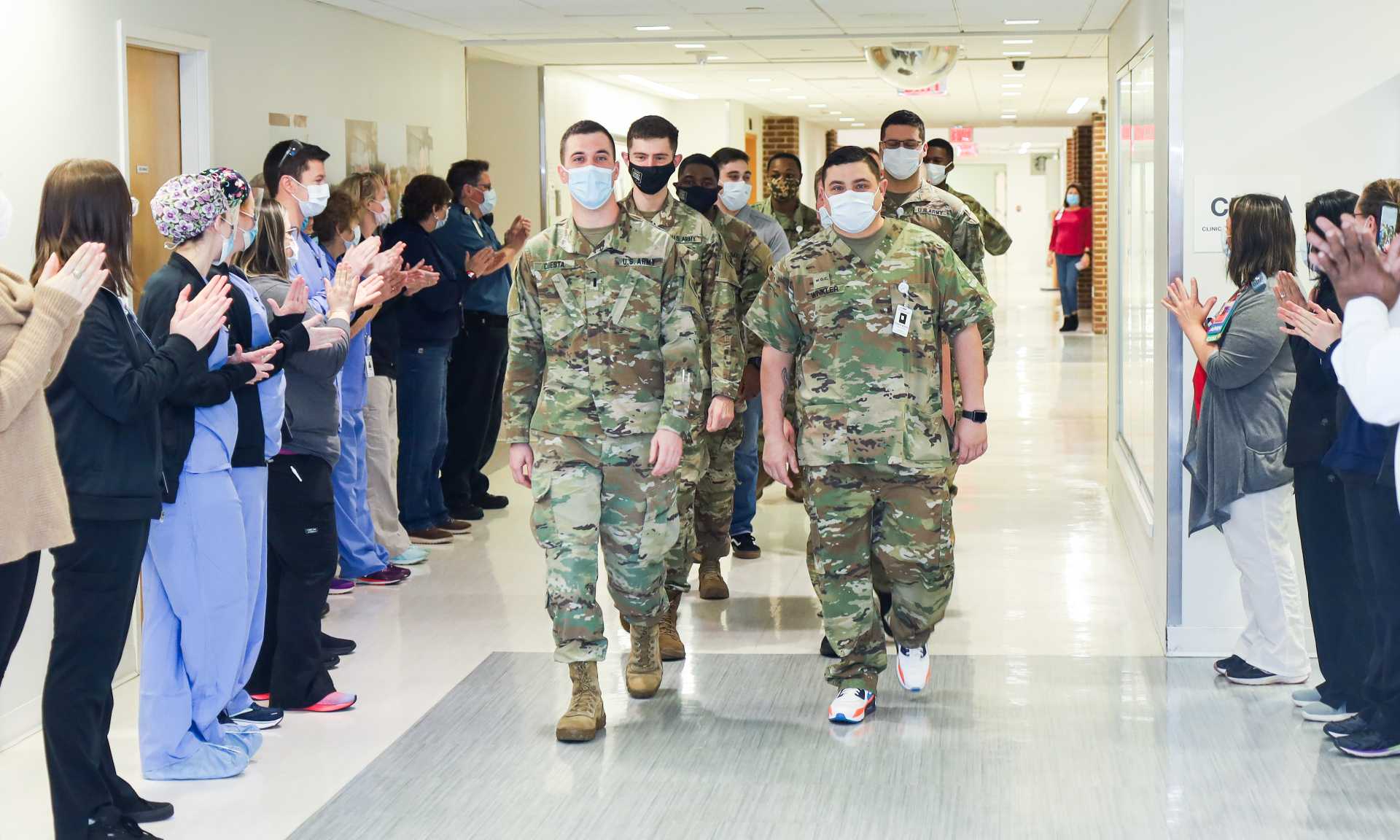 Bayhealth staff line the hallways and cheer for the Delaware National Guard who have helped out at Bayhealth hospitals. 