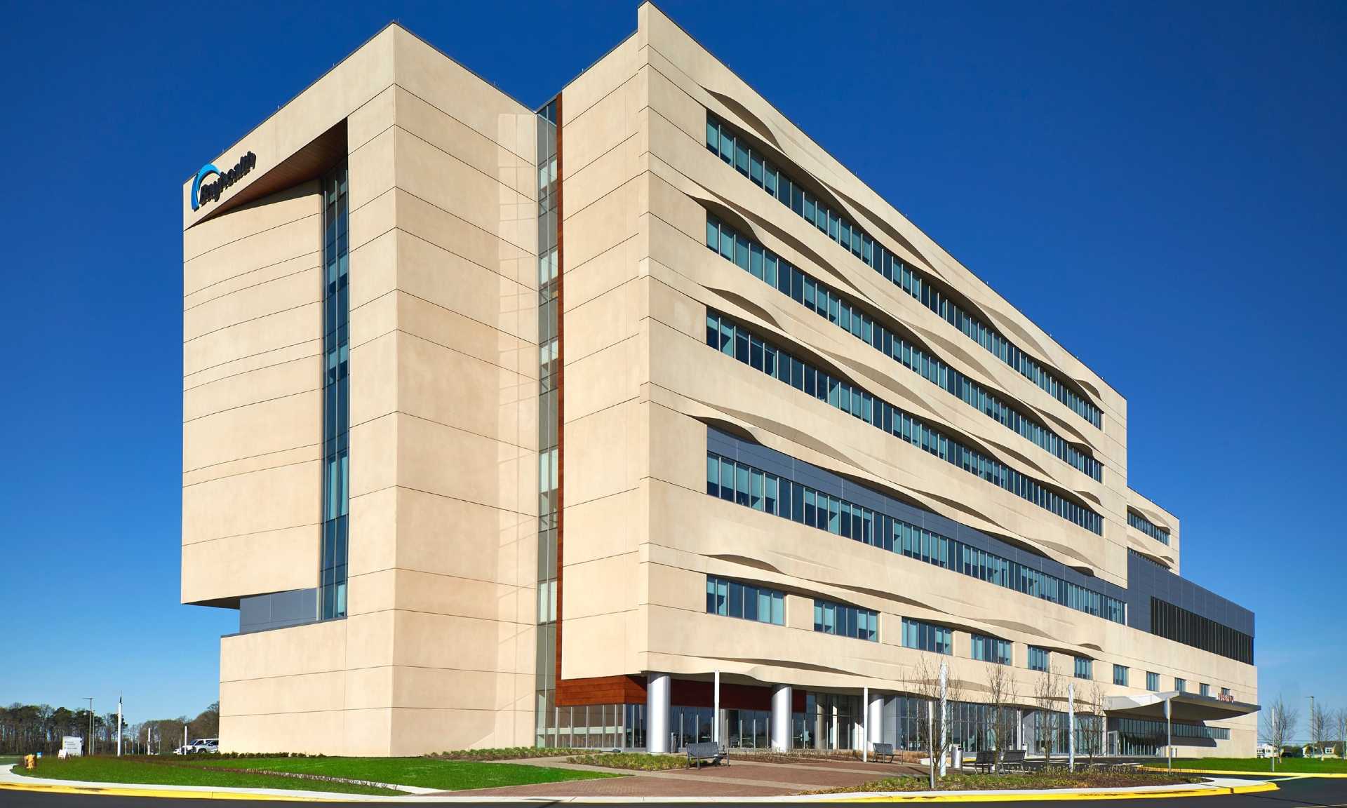 Exterior of Bayhealth Hospital, Sussex Campus against a bright blue sky