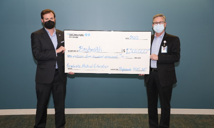 A representative from Highmark and Bayhealth Foundation hold one large check representing a grant Highmark awarded to Bayhealth.