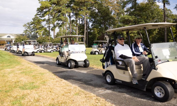 Golfers ride in carts at Bayhealth's fall golf tournament.