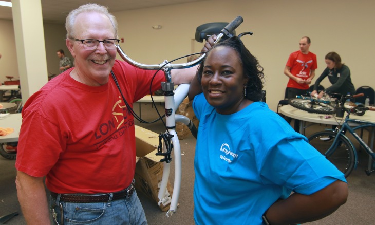 Volunteers assemble bicycles.