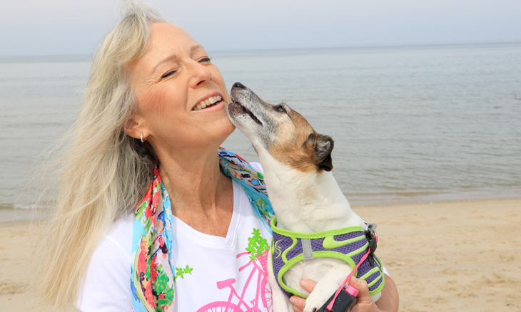 Bayhealth hip replacement patient on the beach with her dog