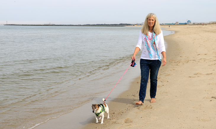 Bayhealth hip replacement patient walking on the beach
