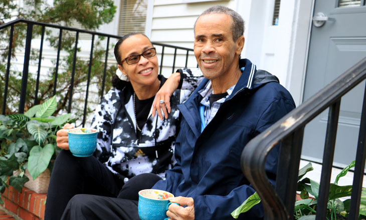 Outpatient palliative care patient and his caregiver relaxing on their porch