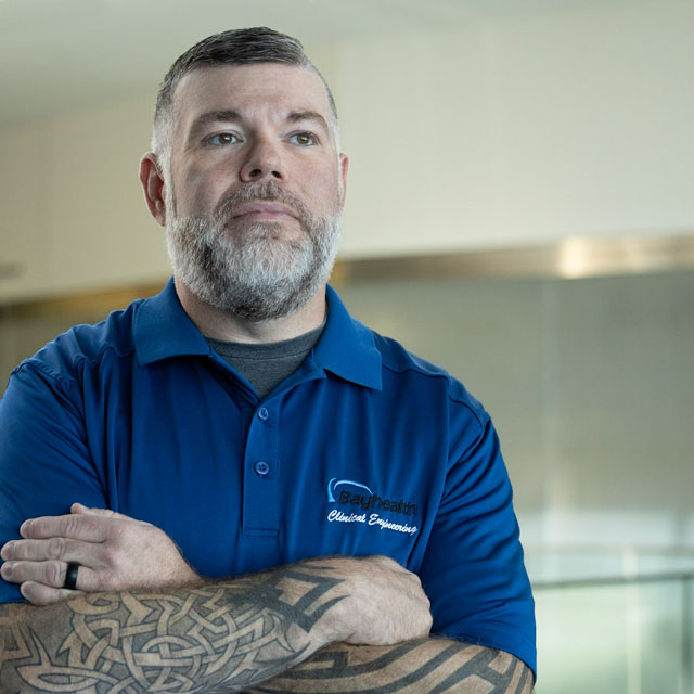 Plant Ops worker crossing arms