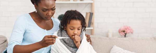 Mother checking child's temperature.
