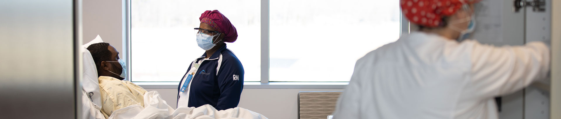 Nurse protecting patient by wearing protective equipment