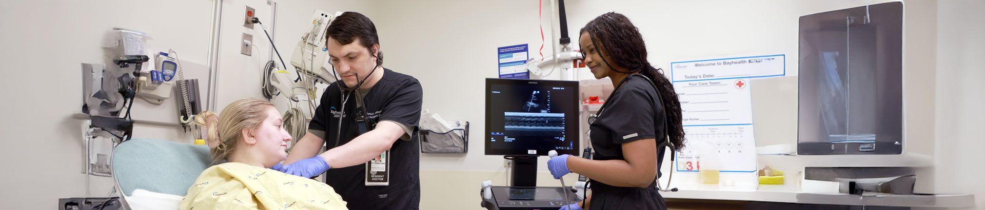 Two emergency medicine residents treating a patient.