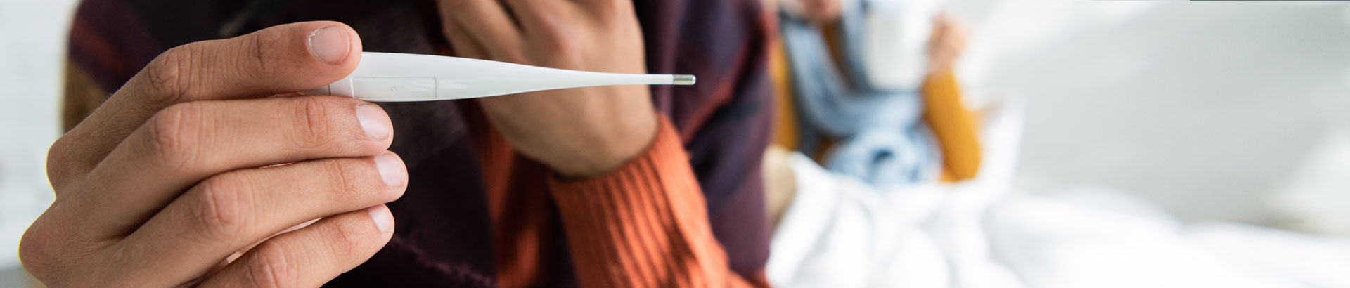 Man holding thermometer