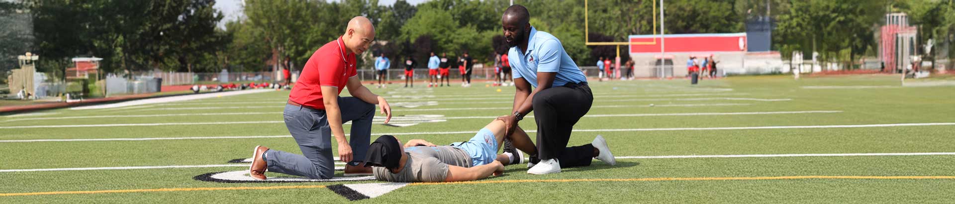 Sports medicine physicians treat an athlete on the football field.