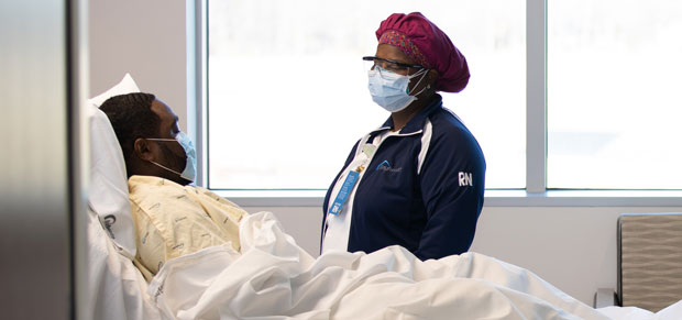 Nurse wearing PPE to protect her patient