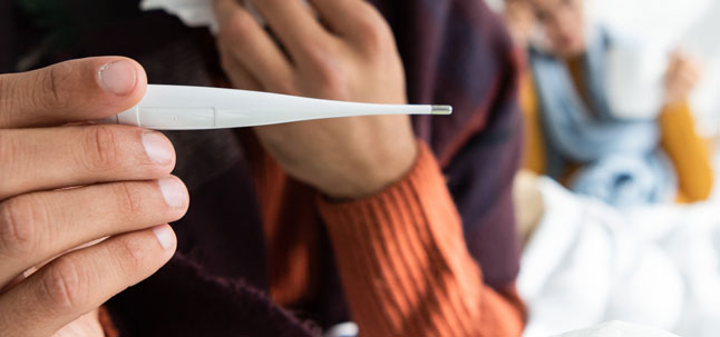 Man holding thermometer