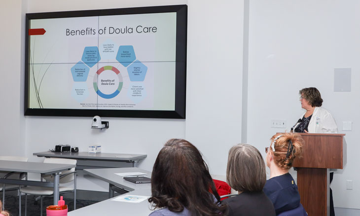 Senior nurse manager gives a presentation on doulas.