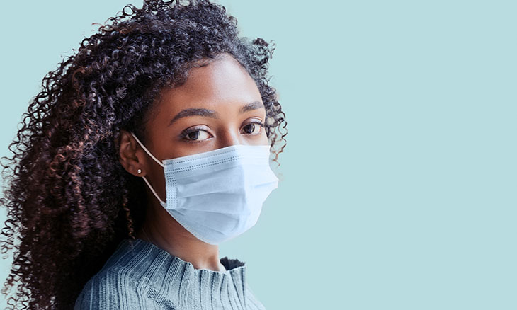 A woman wears a face mask.