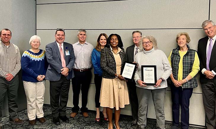 Foundation board members pose with plaques.