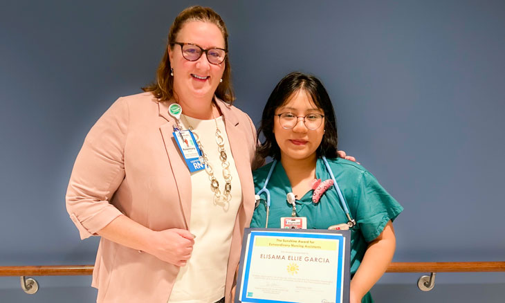 From left to right are Rosmary (Rosi) Wurster, DNP, RN, MPH, NEA-BC, CEN, and Elisama (Ellie) Garcia, CNA, with her Sunshine Award