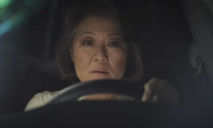 Woman looking out of her car windshield