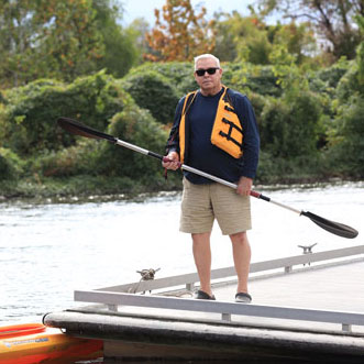TAVR patient John Kiefer on the dock getting ready to go kayaking